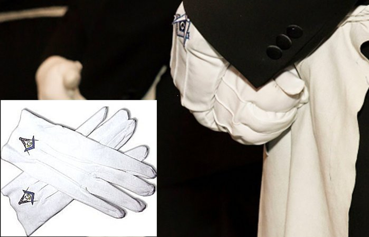 White gloves bearing small Masonic emblems, shown with formal attire
